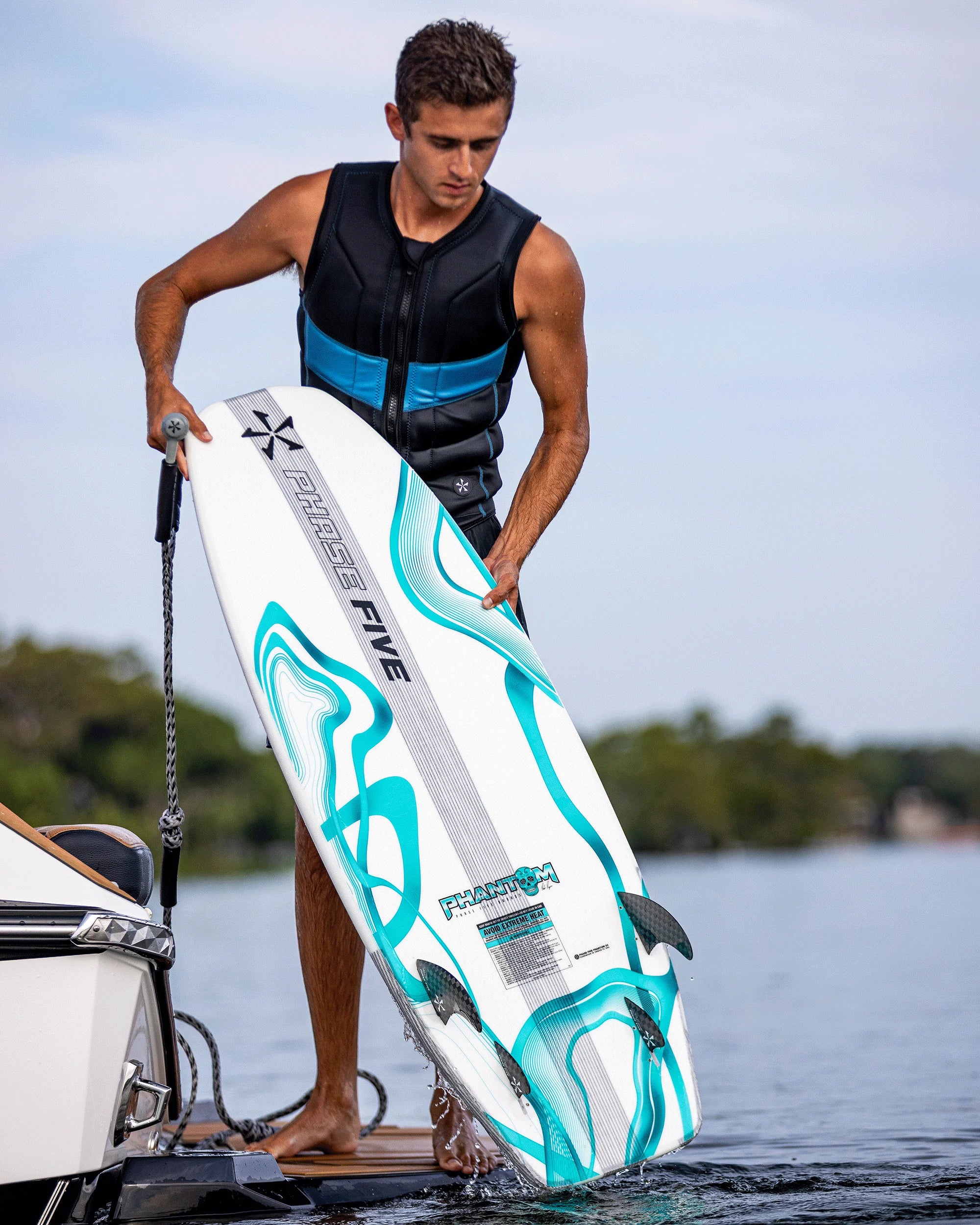 Phase Five Phantom 57 wakesurf board by Parker Payne with quad fin setup and surf style shape Back Of Boat