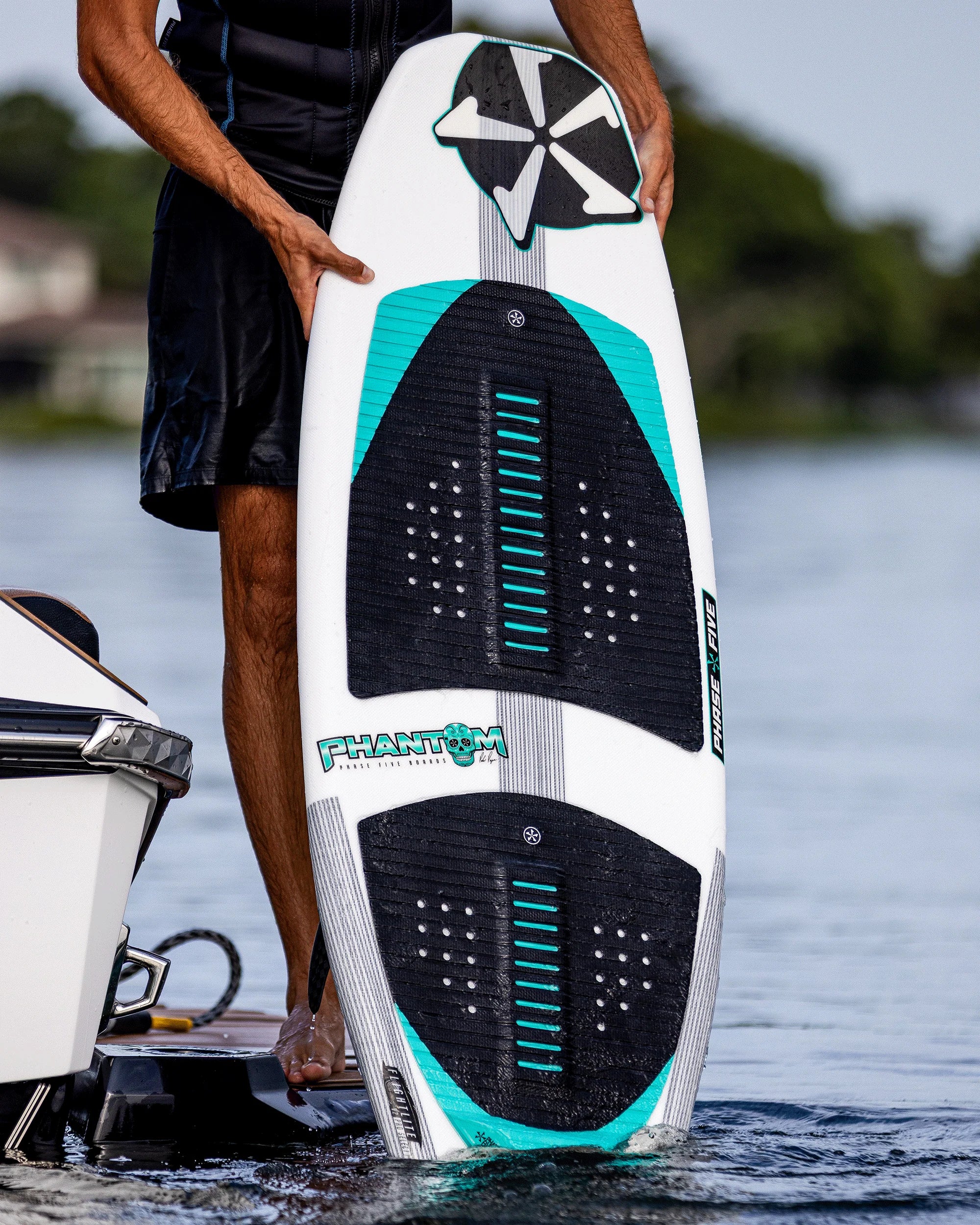 Phase Five Phantom 57 wakesurf board by Parker Payne with quad fin setup and surf style shape Action